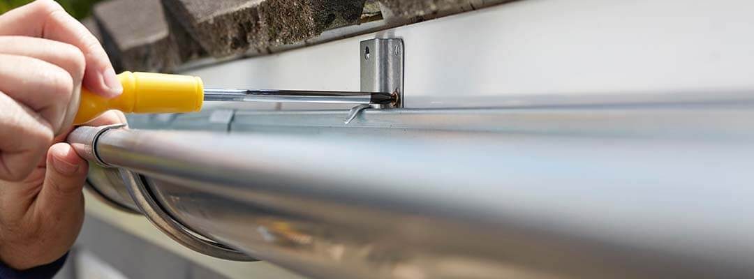 man installing gutter guards in illinois