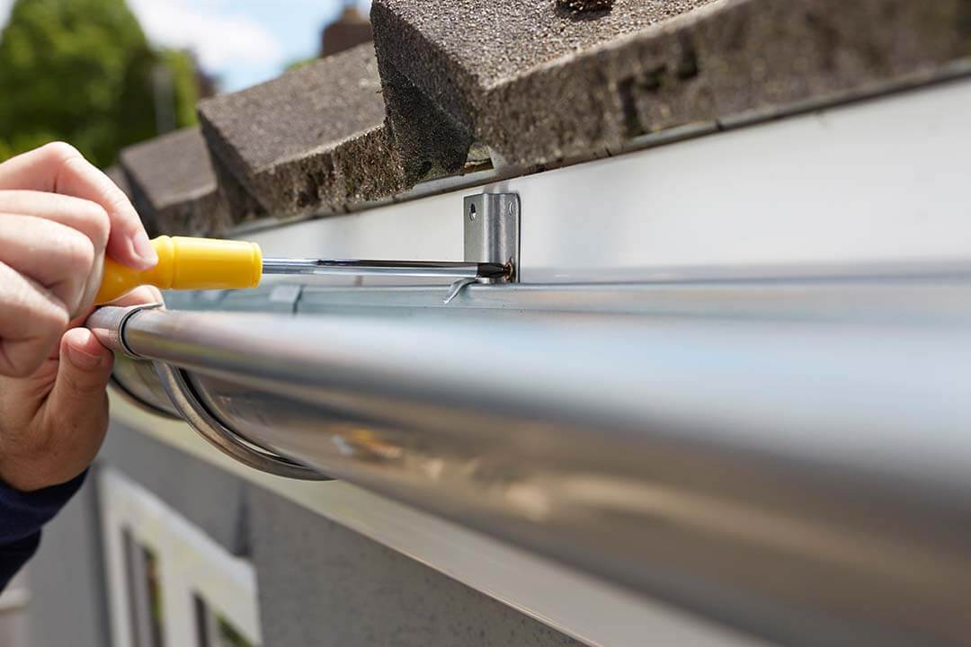 man installing gutter guards in illinois