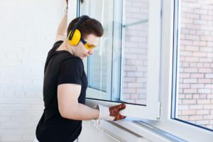 man installing slider windows in home remodel in Ashton IL