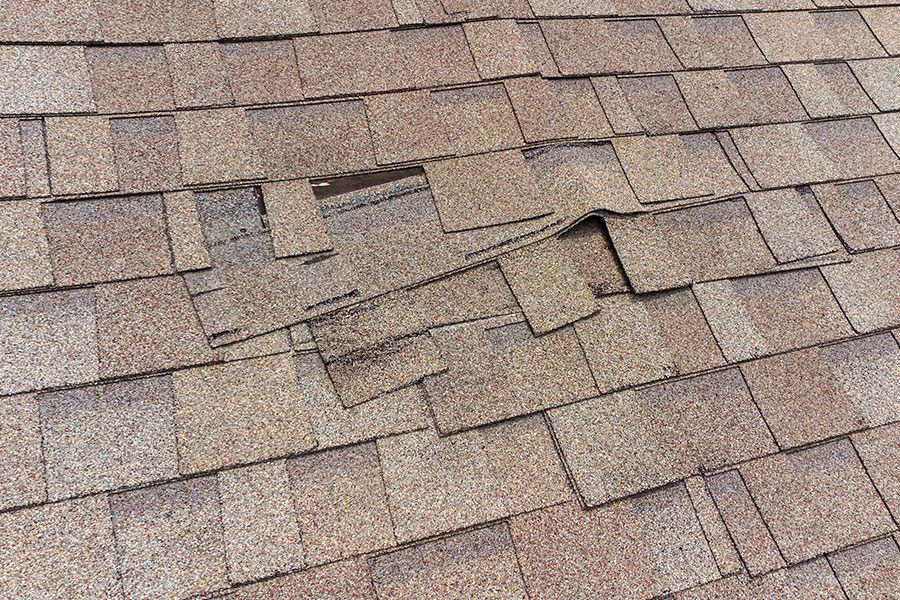 A section of a residential roof where a section of siding has been damaged and needs to be replaced by home improvement professionals in the Quad Cities.