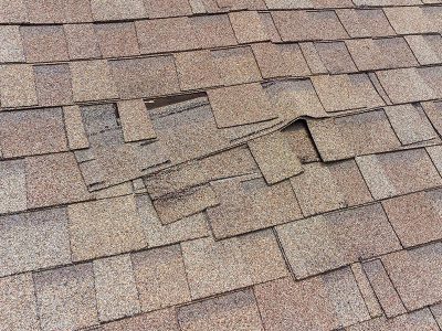 A section of a residential roof where a section of siding has been damaged and needs to be replaced by home improvement professionals in the Quad Cities.