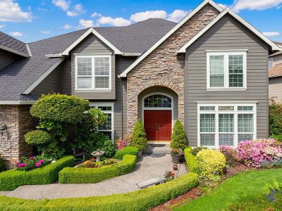 A beautiful home with vinyl siding in the Quad Cities area with a complete roofing system installed by a home improvement company.
