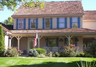 A residential home in the Quad Cities area that has recently had a roof replaced by Mainstream Home Improvement with new shingles and gutter system.