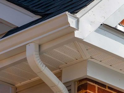 A new gutter and downspout on a residential brick home that has been repaired by Mainstream Home Improvement in Bettendorf, IA.