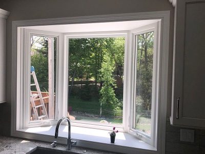 A replacement bay window for a residential kitchen space in Davenport, IL and custom trimming by Mainstream Home Improvement.