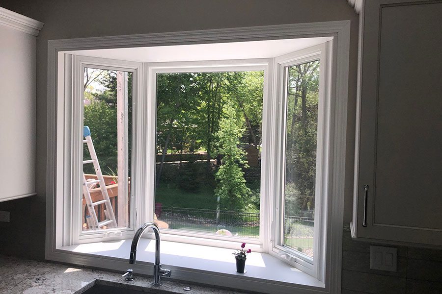 A replacement bay window for a residential kitchen space in Davenport, IL and custom trimming by Mainstream Home Improvement.