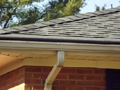 A shingled roof with quality functioning gutters on a home in Davenport, IA.