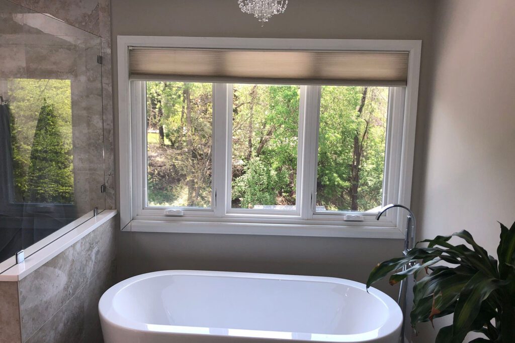 A casement window above a tub in a bathroom in a home in Davenport, IA.
