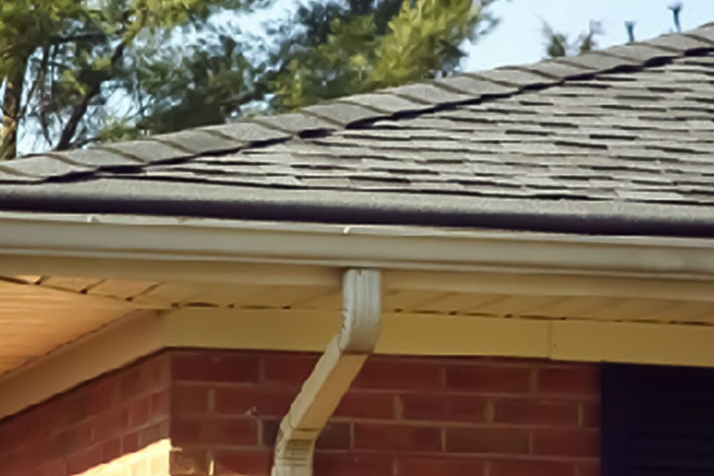 A shingled roof with quality functioning gutters on a home in Davenport, IA.