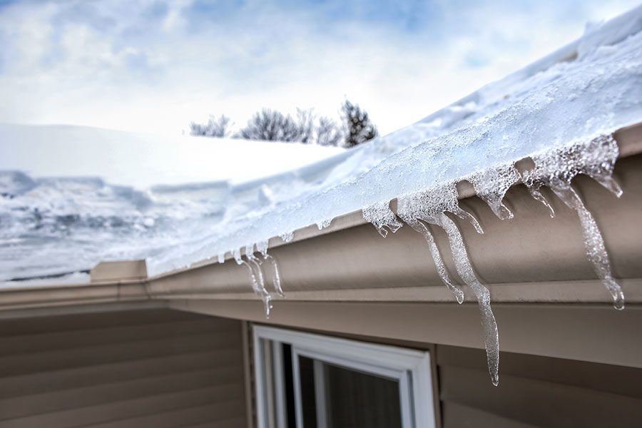 An ice dam forms on the roof of a home in Bettendorf, IA, threatening the structure of the roof.
