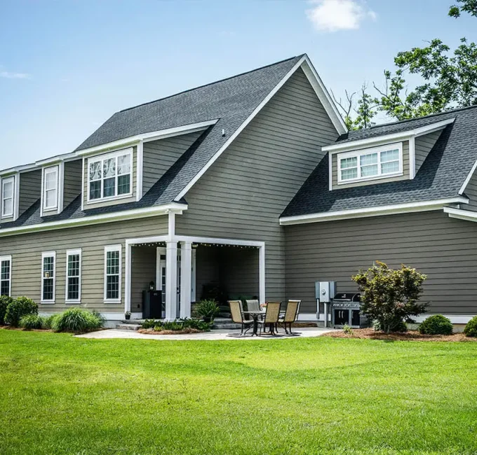 A residential home in Bettendorf, IA that has had a new roof installed with GAF Timberline shingles by a professional roofing contractor.