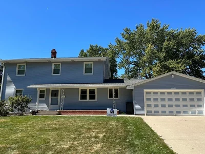 This is a photo of a house with a new roof and siding in Rock Island, IL installed by Mainstream Home Improvement.
