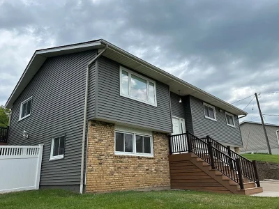 This is a photo of a house with newly installed gray siding by Mainstream Home in Taylor Ridge, IL.