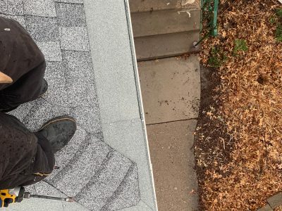 rock island gutter installation - contractor working on corner gutter system, during