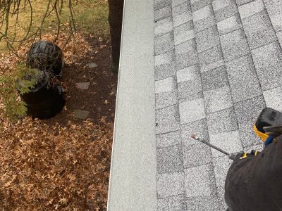 rock island gutter installation - contractor working on roof/gutter system, during