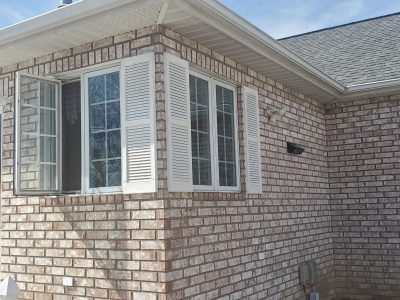 muscatine window installation - exterior corner of brick house, before
