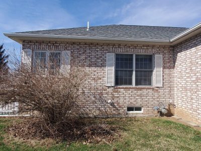 muscatine window installation - exterior side of brick house, before - 2