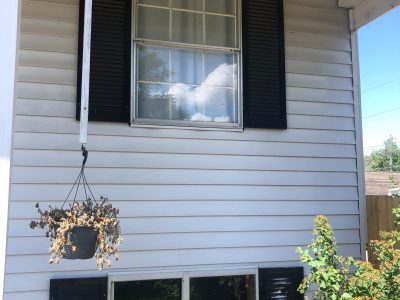camanche window replacement - exterior windows of two-story white house, before - 2