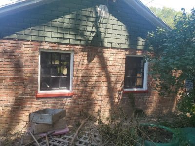 moline window replacement - exterior back of house with two old windows, before