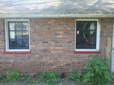 moline window replacement - exterior side of house with two old windows, before