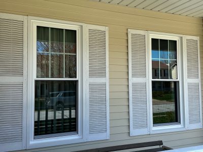 bettendorf roofing replacement - exterior of house with 2 new living room windows, after