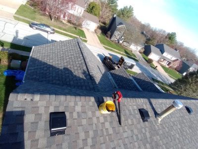 bettendorf roofing replacement - contractor working on roof, during