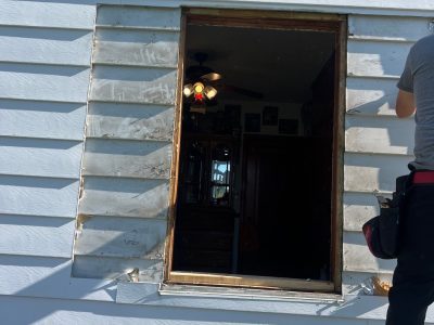moline window installation - two workers installing window, during - 2