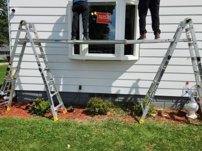 moline window installation - two workers installing window, during - 3