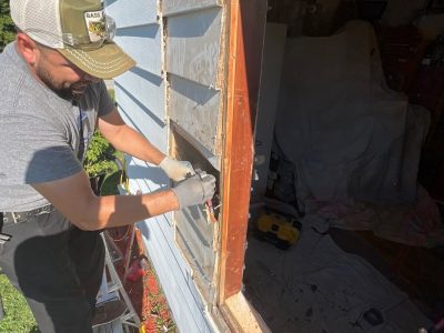 moline window installation - worker fixing window frame, during