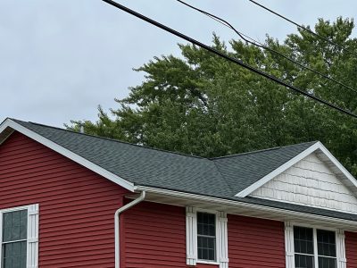 east moline roofing replacement - new gray roof on red house, after - 2