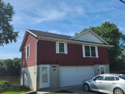 east moline roofing replacement - exterior street view of red two-story house, before - 2