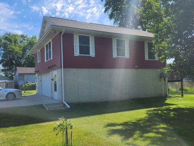 east moline roofing replacement - exterior side of two-story red house, before - 2