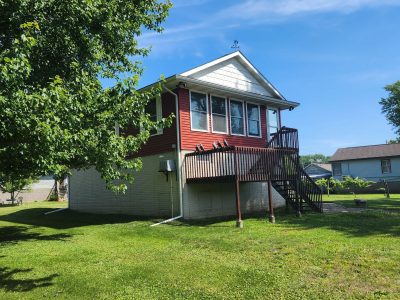 east moline roofing replacement - exterior street view of red two-story house, before