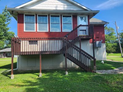 east moline roofing replacement - exterior front of two-story red house with porch, before