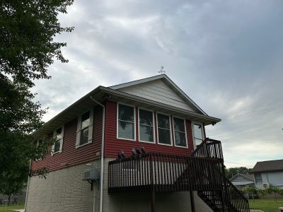 east moline roofing replacement - exterior front of two-story red house, before