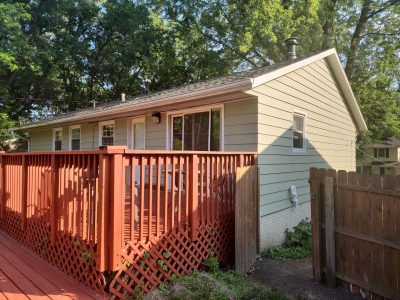 bettendorf siding replacement - back of house with deck, before