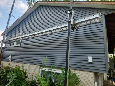 bettendorf siding replacement, side of house with scaffolding, during - 2