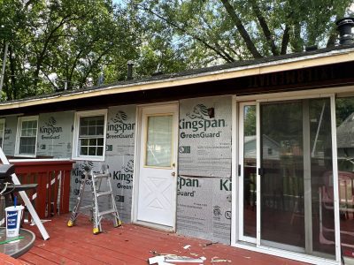 bettendorf siding replacement, back of house with deck, during