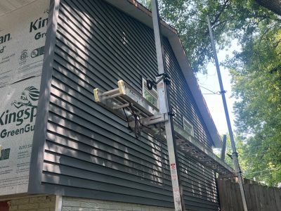 bettendorf siding replacement, side of house with scaffolding, during