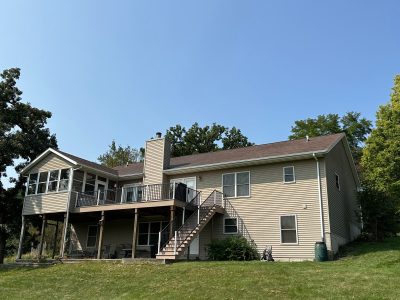 blue grass roofing installation - wide view of house with new roof, after