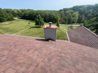 blue grass roofing installation - new roof surrounding chimney, after