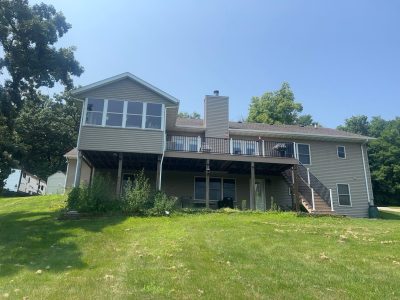 blue grass roofing installation - wide view of entire house, before