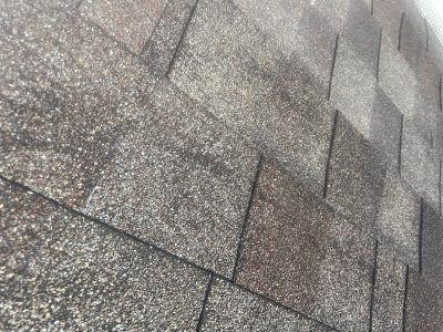 blue grass roofing installation - shingles of old grey roof, before