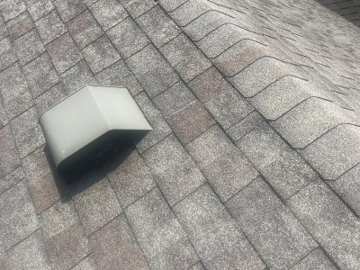 blue grass roofing installation - top of old grey roof, before