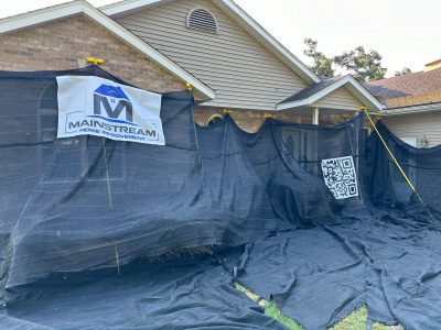 blue grass roofing installation - construction protection tarps on house, during