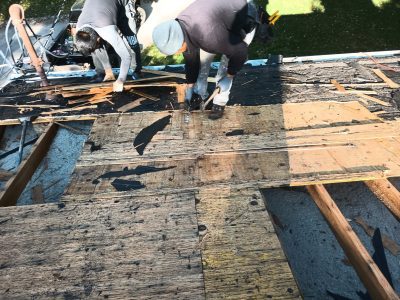 coal valley roofing installation - workers removing old roof layers, during