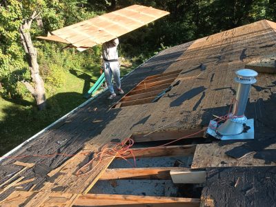 coal valley roofing installation - workers installing new roof layers, during