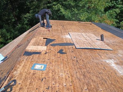 coal valley roofing installation - workers installing new roof layers, during - 2