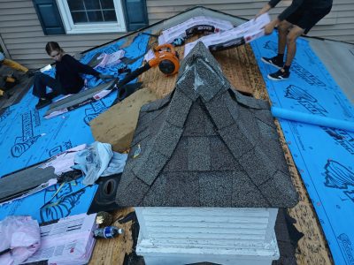 coal valley roofing installation - workers removing old roof tiles, during