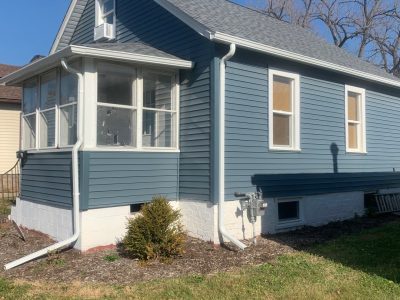 east moline gutter replacement - side view of blue house with new white gutters, after